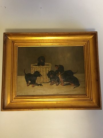 Painting, oil on canvas in gold frame, of dogs (dachshund) . Signed A. Ritzau 1916