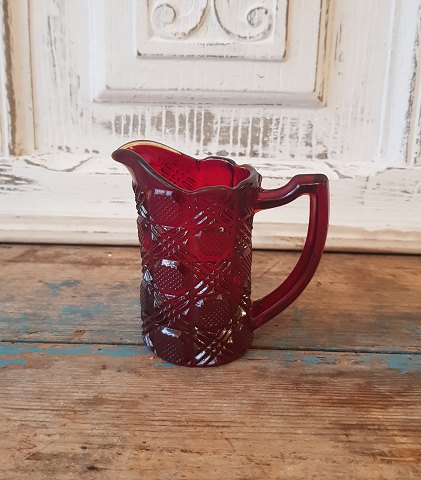Cream jug in red pressed glass from Fyens Glasværk