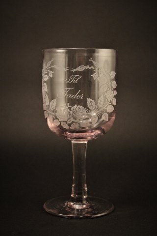 Old commemorative glass from Holmegaard glassworks with fine engraved floral decorations and writing "Til Fader" H:16,5cm. Dia:7.5cm.