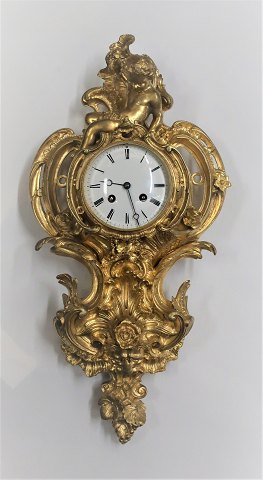 Napoleon lll cartelur of gilded bronze with putti figure. Height 50 cm. Produced 1870-1890. The clock works.