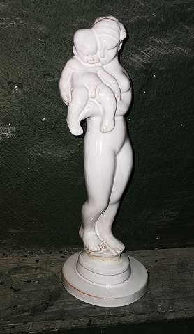Kai Nielsen: Mother with Child "The Lazy Beast" for the Kähler factory. DEFECT: The figure broken into two parts. Repair at the transition between feet and plinth. Otherwise in good condition. Signed HAK, Danmark and modelnumber on the bottom. H. 31½ cm (12.11 inches).