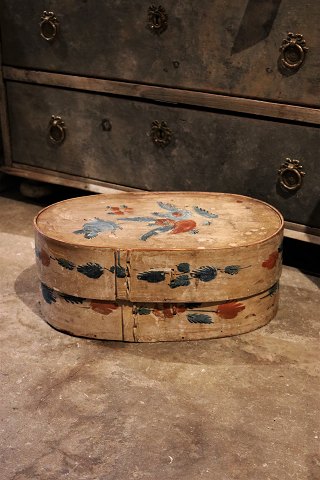 Swedish 1800 century oval wooden box with original paint with floral motif.H:20cm. L&W:42x26cm.
