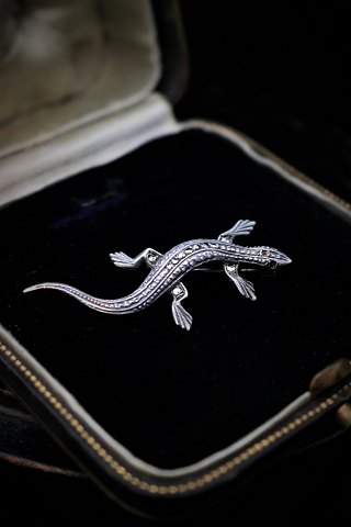 Old brooch in silver in the form of salamanders with lots of small shiny magazines. L:5cm.