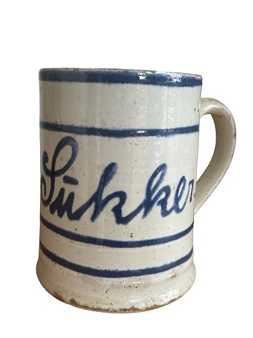 Almue earthenware mug with handle, Denmark. White coating with blue paint and clear glaze. Late 1800s.