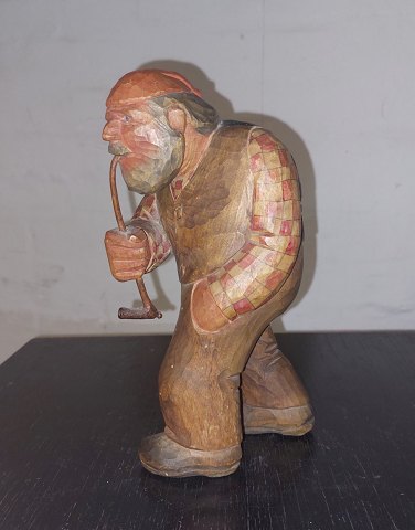 Wooden figure of a man smoking a pipe​