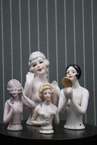 Fine, old porcelain half dolls.Has been used as a top on old pincushions...