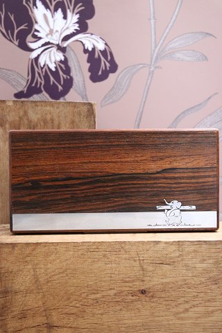 Oblong box in rosewood decorated with silver inlay with a motif of a small elephant carrying a tree trunk...