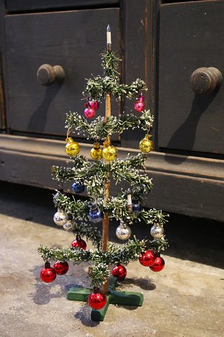 Antique miniature Christmas tree,  decorated with lots of small colored Christmas glass balls...