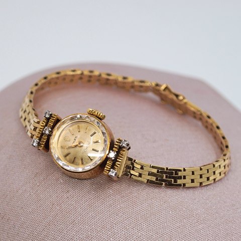 Rolex; Orchid dameur af 18 kt. guld med diamanter, med lænke i 14 kt. guld
