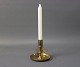 Flat candlestick in brass from the year 1880. It has been repaired and is of good quality.