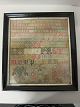 Navneklud fra 1886Uld broderet på hør Original rammeNavnekludens mål: 39cm x 35,5cmRammens mål: 46,5cm x 43cmVi har et godt udvalg af navnekludeKontakt os for yderligere information