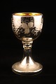 1800th century wine glass made of mercury glass, decorated with etched wine leaves outside.
