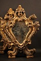 A pair of decorative French 1800 century wall mirrors with fine decorated frame with old gilding.35x26cm.