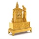 Fransk empire kaminur i forgyldt bronze med bedende kvinde foran statue af Jomfru Maria. Frankrig ca. år 1820. H: 49cm. B: 36cm