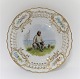 Royal Copenhagen. Tallerken med gennemskåret roset. Diameter 19 cm. Motiv ; Fisker fra Skovshoved. Produceret før 1923.