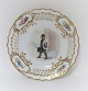 Royal Copenhagen. Tallerken med gennemskåret roset. Diameter 19 cm. Motiv ; Bybud. Produceret før 1923.