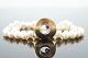 Ole Lynggaard; Luna clasp of 14k gold and white gold with a sapphire and a diamond
