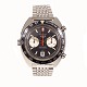 Heuer Autavia, stål. Ref 1163, kaldet "Derek Bell" efter den britiske racerkører. Leveres med original "beads-of-rice"-lænke. Ca. år 1970. D: 42mm