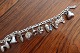 Bracelet, silver, Bismark, with 10 charms- Poodle- Jug- Dummy- Hat- Bell- Crown- Acorn- Wooden shoe- Veteran car/ Vintage car- MillCharms with partly worn down blue enamelAbout 1960L: 15cmThe bracelet and the charms never polis