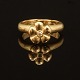 A 14kt golf "Flower" ring by Charlotte Lynggaard, Copenhagen. Ringsize: 58. W. 8,7gr