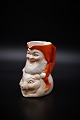 Old Christmas pitcher in porcelain of Santa riding on pig. Height: 11,5cm.