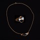 Set of gilt sterlingsilver necklace and ring with enamel. Made by Erik Magnussen for A. Michelsen, Copenhagen. Necklace L: 40cm. Ringsize: 50