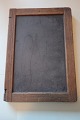 An old blackboard/slate mad of slate with an edge of wood