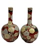 Pair of Asian vases, presumably Japanese. 20th century. Iron glaze with flowers.