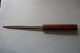 An old paper knife/paper cutter with a handle made of woodThe handle is with text for advertising with nameText: "Rise Hjaruo Maskinstation, Chr. Lauritsen, Tlf.: 6 29 54", DenmarkThe blade of the knife is with the words: "tainless Steel" and so mad