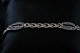 Gold bracelet with inlaid swarovski stones and blue sapphire in 14 carat gold, with box lock