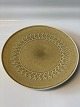 Relief stoneware, round dish on a low foot.Measures 26.7 cm