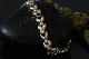 Elegant and classic gold bracelet in 14 carat gold, with inlaid stones and box lock.