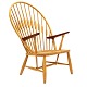 Hans J. Wegner Påfuglestol. Hans J. Wegner: JH 550 Påfuglestol i ask med armlæn af teak og sæde i papirgarnsflet. Fremstillet af Johannes Hansen. Design fra 1947