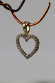 Heart-shaped pendant in 14 carat gold, with diamonds. Stamped 585. Very exclusive.