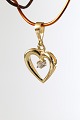 Heart-shaped pendant in 14 carat gold, with a brilliant. Stamped 585. Very exclusive.