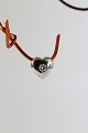 Small heart-shaped pendant for necklace, in 14 carat white gold, with a brilliant. Stamped 585