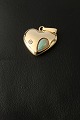 Heart-shaped pendant with brilliant and opal in 14 carat gold. Very unique and elegant piece of jewelry.
