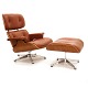 Eames Lounge chair with ottoman in red/brown colored leather. Nice condition. Chair H: 90cm. W: 84cm. D: 70cm. Ottoman: 65x55cm