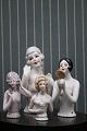 Fine, old porcelain half dolls.Has been used as a top on old pincushions...