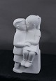 Stone Art white figurine from Marbell, The Netherlands. Couple of siblings on a bench.