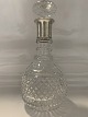 Crystal carafe with silver base.Height.: 27 cm.