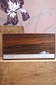 Oblong box in rosewood decorated with silver inlay with a motif of a small elephant carrying a tree trunk...
