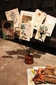 Old display for postcards, photos or business cards. The display is in black metal on a wooden base...