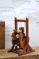 Cute, small plush monkey sitting in an old wooden swing...