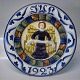 1923 Den kongelige porcelænsfabriks Store Juleplatter af Fajance fra Aluminia 1235-1175 Julerelief 1923 Engel med skriftbånd R. Harboe 31,5 cm 