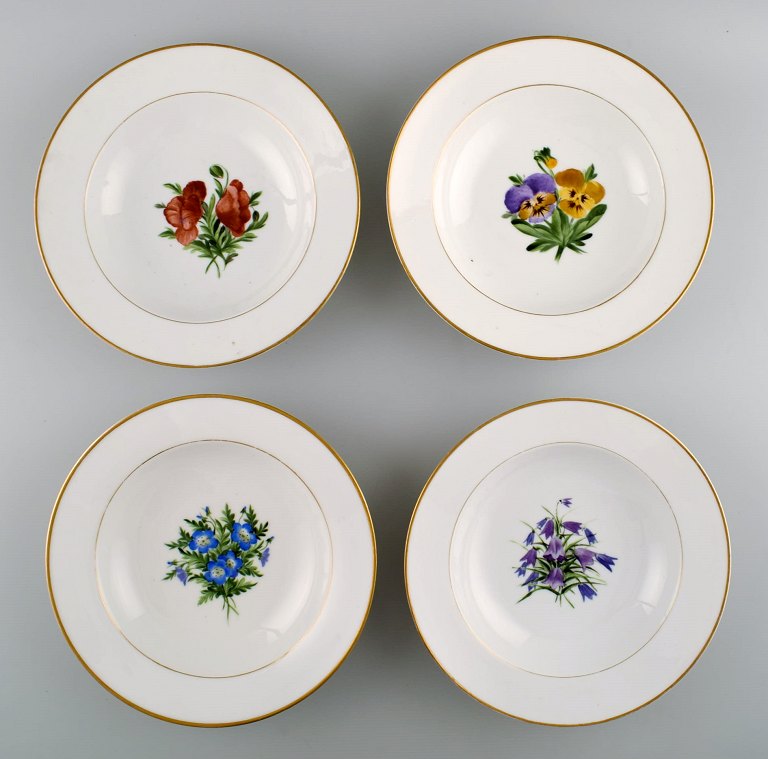 4 antique Royal Copenhagen deep plates in flora danica style.