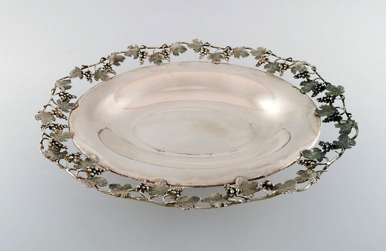 Large silver bowl pierced with grape vines.