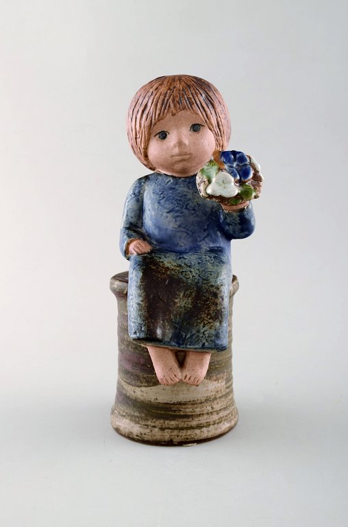 Lisa Larson for Gustavsberg. Girl with flowers in glazed ceramics. 20th century.