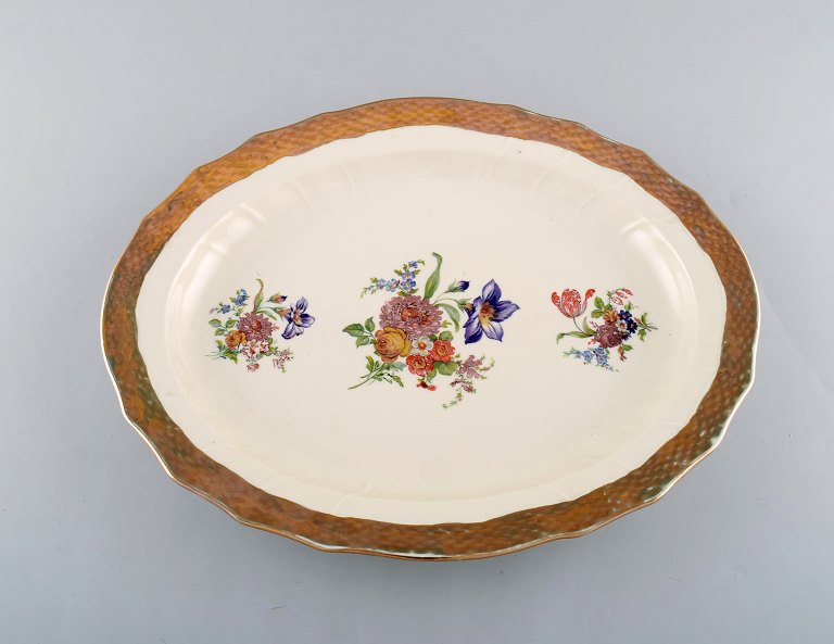 Royal Copenhagen serving dish in porcelain with floral motifs and gold border. Mid 20th century.