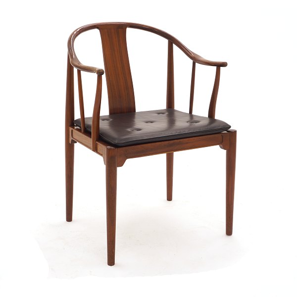 Hans J. Wegner, 1914-2007: Kinastolen i mahogni. Med etiket fra Illums Bolighus. Leveres med ny sort læderhynde. God stand. Armlæn med lettere patinering